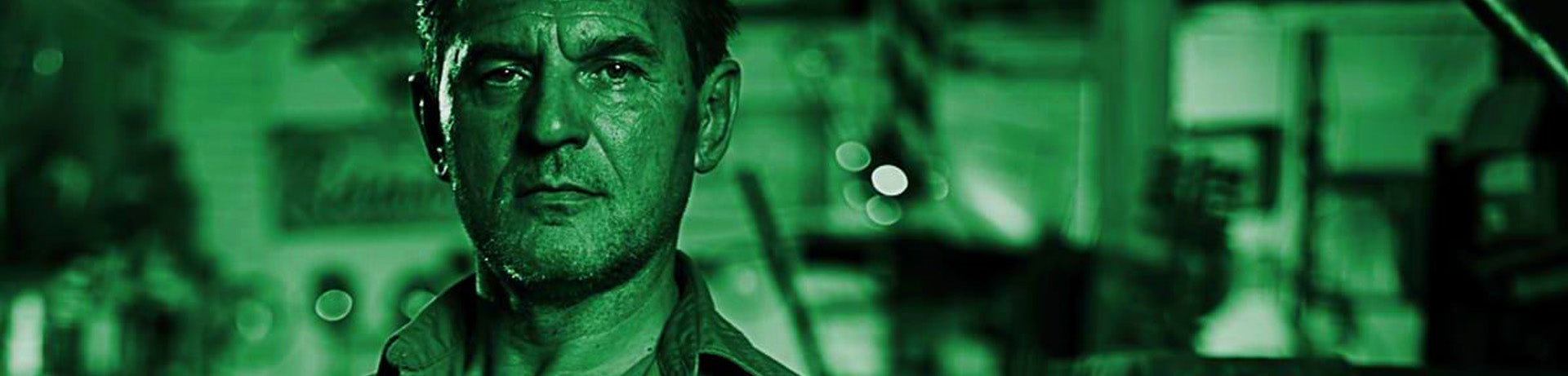 Person wearing a headset in a green-tinted setting with blurred background